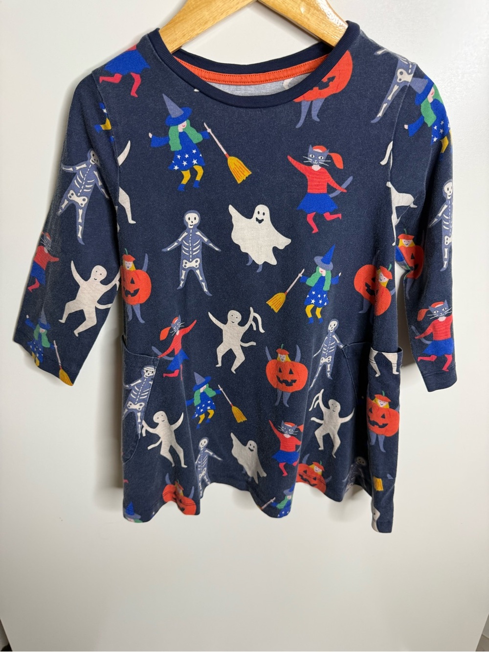 Mini Boden Halloween dress featuring pumpkins, ghosts, and skeletons, girls 5/6